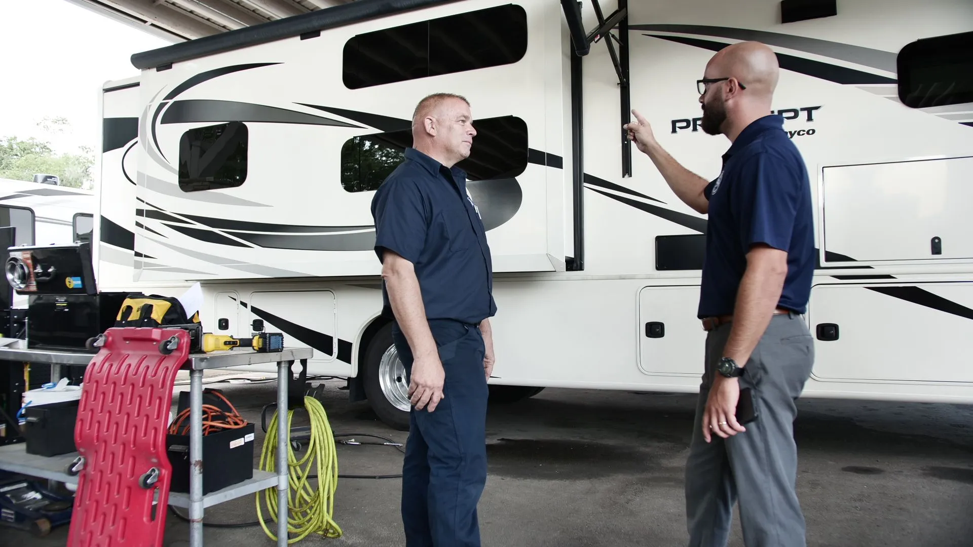 Technician performing a mobile RV inspection on a motorhome in the East Valley