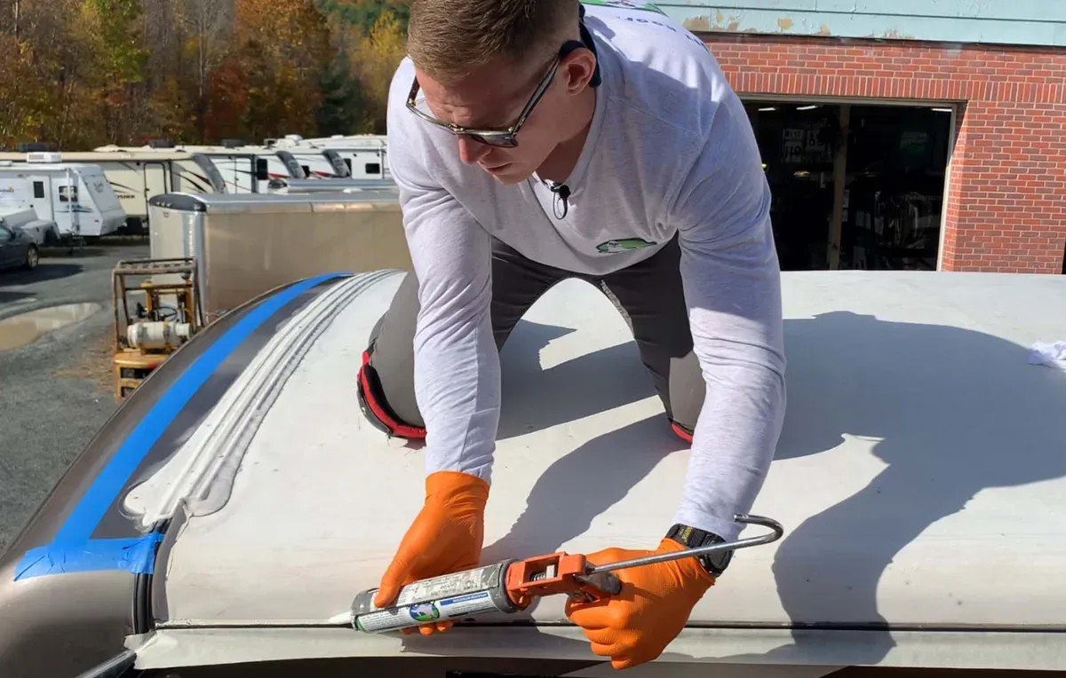Cracked RV roof sealant being repaired and resealed during a mobile visit in the East Valley